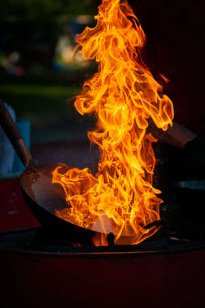 Cooking street food on a hot frying pan. Street food festivalの写真素材