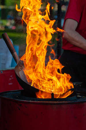 Cooking street food on a hot frying pan. Street food festivalの写真素材