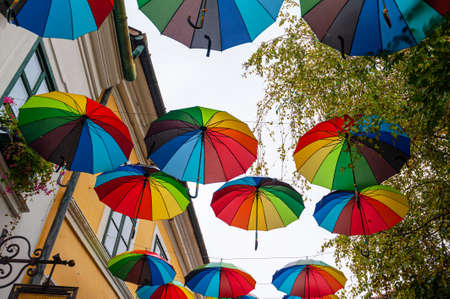 Colorful umbrellas background with blue sky in the city street decorationの写真素材