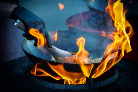 Cooking street food on a hot frying pan. Street food festival