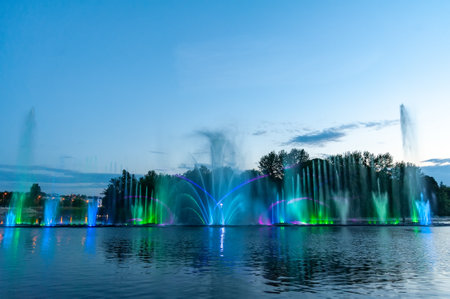 Musical fountain with laser animations. Night laser fountain show, on the Roshen embankment, the Ukrainian city of Vinnitsa.の写真素材