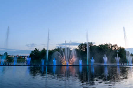 Musical fountain with laser animations. Night laser fountain show, on the Roshen embankment, the Ukrainian city of Vinnitsa.の写真素材