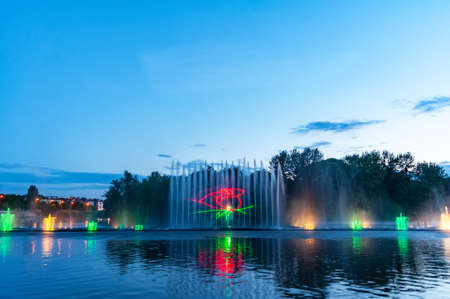 Musical fountain with laser animations. Night laser fountain show, on the Roshen embankment, the Ukrainian city of Vinnitsa.の写真素材