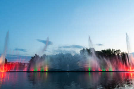 Musical fountain with laser animations. Night laser fountain show, on the Roshen embankment, the Ukrainian city of Vinnitsa.の写真素材