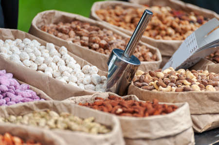 Assorted nuts in paper boxes for sale in the market. Selective focus.の写真素材