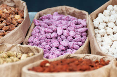 Assorted nuts in paper boxes for sale in the market. Selective focus.の写真素材