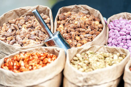 Assorted nuts in paper boxes for sale in the market. Selective focus.の写真素材