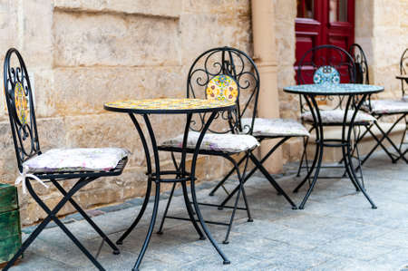 Outdoor cafe in the old town. Chairs and table on empty terrace at cafe.の写真素材