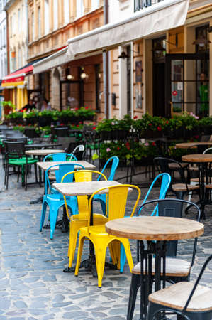 Outdoor cafe in the old town. Chairs and table on empty terrace at cafe.の写真素材