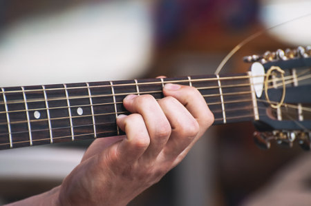 The musician plays the acoustic guitar. Musician's hand close-up.の写真素材