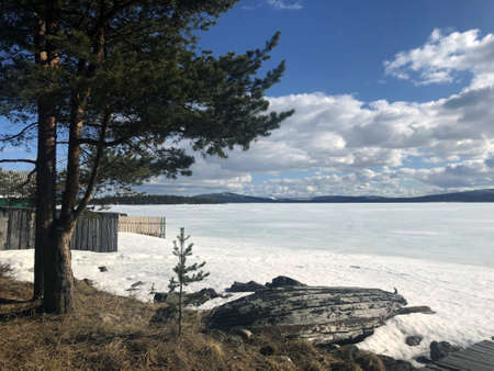 winter frozen lake in the Russian Outback on a Sunny day in springの写真素材