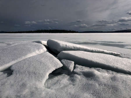 winter frozen lake in the Russian Outback on a Sunny day in springの写真素材