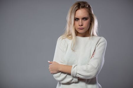 Beautiful blonde girl in a bad mood.の写真素材