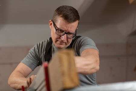 Portrait of a male carpenter at work in a carpenters shop.