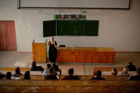 Top view of the classroom in which a female teacher teaches a lesson