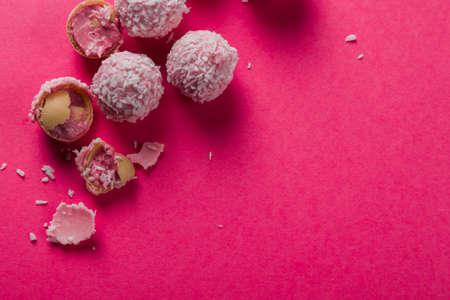 Lots of delicious coconut candies on a bright pink background. Photo for postcard, wallpaper, banner. High quality photoの写真素材