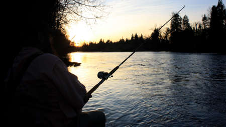 This is an image of fishing in the summer along a river.の写真素材