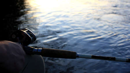 This is a fishing pole at sunset.の写真素材
