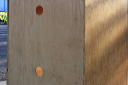 This is the back of a series of shelves with holes for power cables.の写真素材