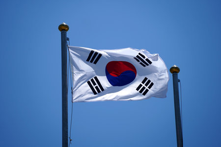 South Korea flag waving in the wind with blue sky background, South Korea flagの写真素材