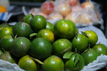 Fresh tropical fruit calamansi piled up and soldの写真素材