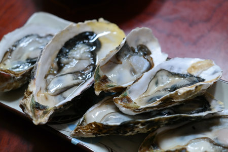 Fresh oysters on a plate in a restaurant, close-upの写真素材