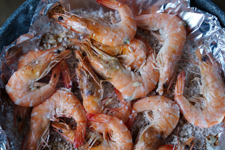 Grilled shrimps baked red on a pan and foilの写真素材