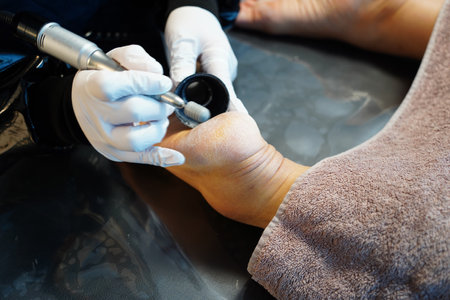 process of pedicure at beauty salon, closeup of hands