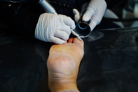 process of pedicure at beauty salon, closeup of legsの写真素材