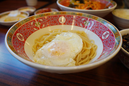 Noodles with fried egg on a plate.の写真素材