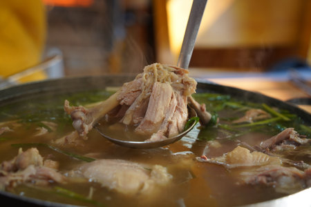 Korean food made by boiling whole chicken with garlic and seasoning it with saltの写真素材