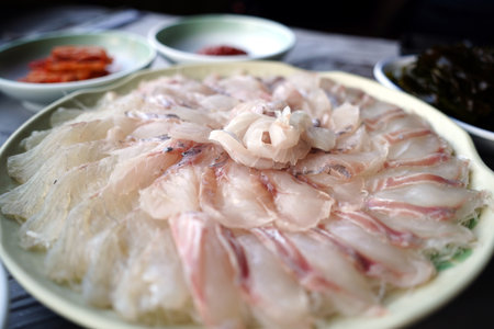 Fresh raw pangasius fish on plate with soy sauce.の写真素材