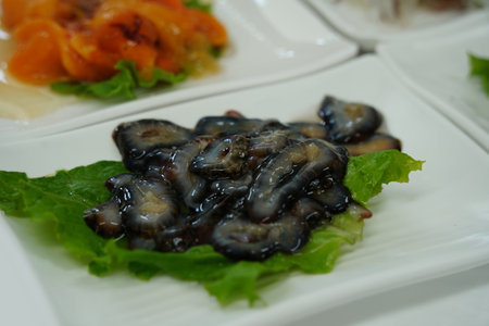 Sliced Sea Cucumber Appetizer on White Plate with Lettuce