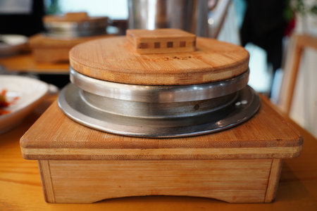 Steaming Korean Rice Pot on Wooden Tableの写真素材