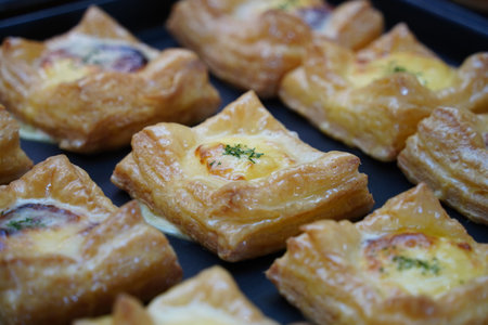 Egg Puff Pastry with cheese and herbs on black trayの写真素材