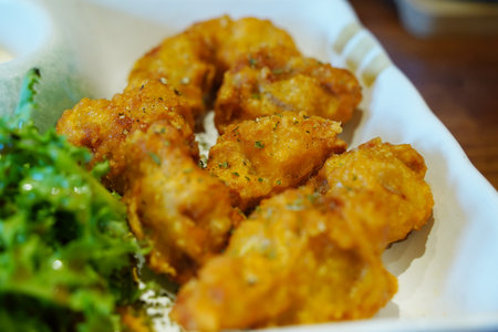 Golden Fried Chicken Karaage with Green Garnishの写真素材