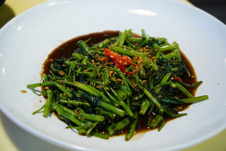 Authentic Thai Stir-fried Water Spinach (Morning Glory) in Oyster Sauce with Chili and Garlicの写真素材