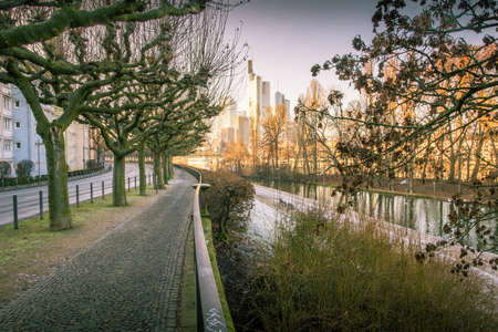 A walking path in Frankfurt Germany with the city's modern skyline int he background.のeditorial素材