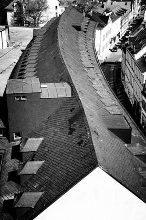 Black and white image of the roof of a long building with an S-curved ridge lineの写真素材