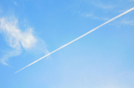 white contrails in the blue sky