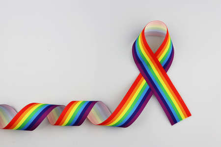 Rainbow ribbons symbolize gay and LGBT pride on a white background.の写真素材