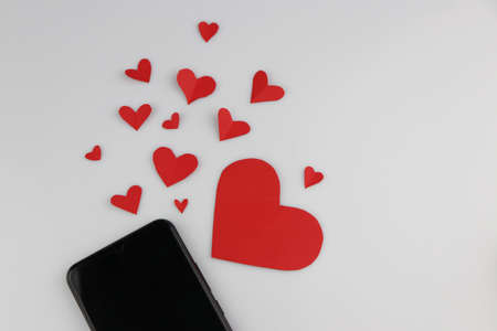 Mobile phone with red heart shape Valentine's Day Messaging Conceptsの写真素材