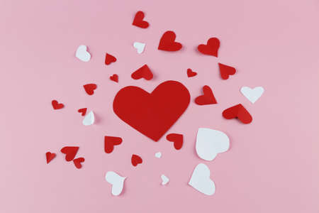 Cut the heart-shaped paper, put on a pink background. Valentine's Day Concepts
