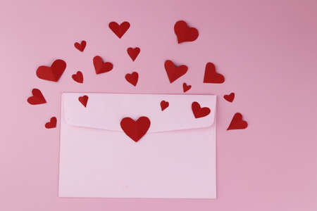 Cut the heart-shaped paper, put on a pink background. Valentine's Day Concepts