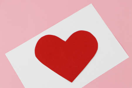 A blank white card for filling text and with handmade heart-shaped paper. Valentine's Day Concepts.