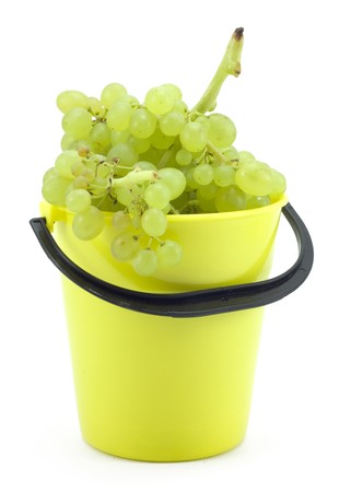 yellow bucket with grapes on a white backgroundの写真素材