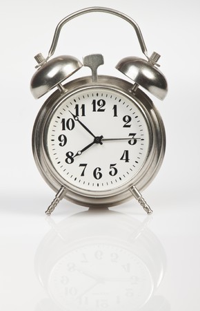 Metal alarm clock on a black background for your designの写真素材