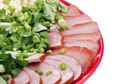 Tasty meat with sliced onion and parsley on a white backgroundの写真素材