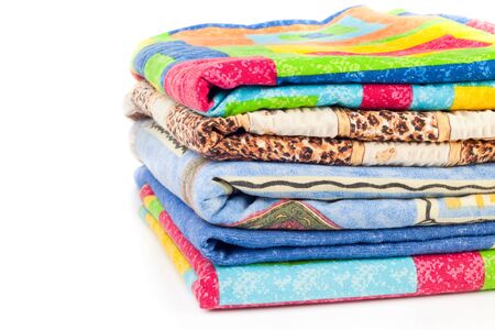 Pile of linen kitchen towels on a white background 