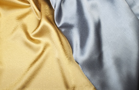 Smooth elegant gold and silver silk can be used as backgroundの写真素材
